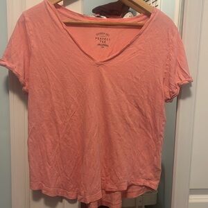 Salmon colored, cropped short sleeved shirt